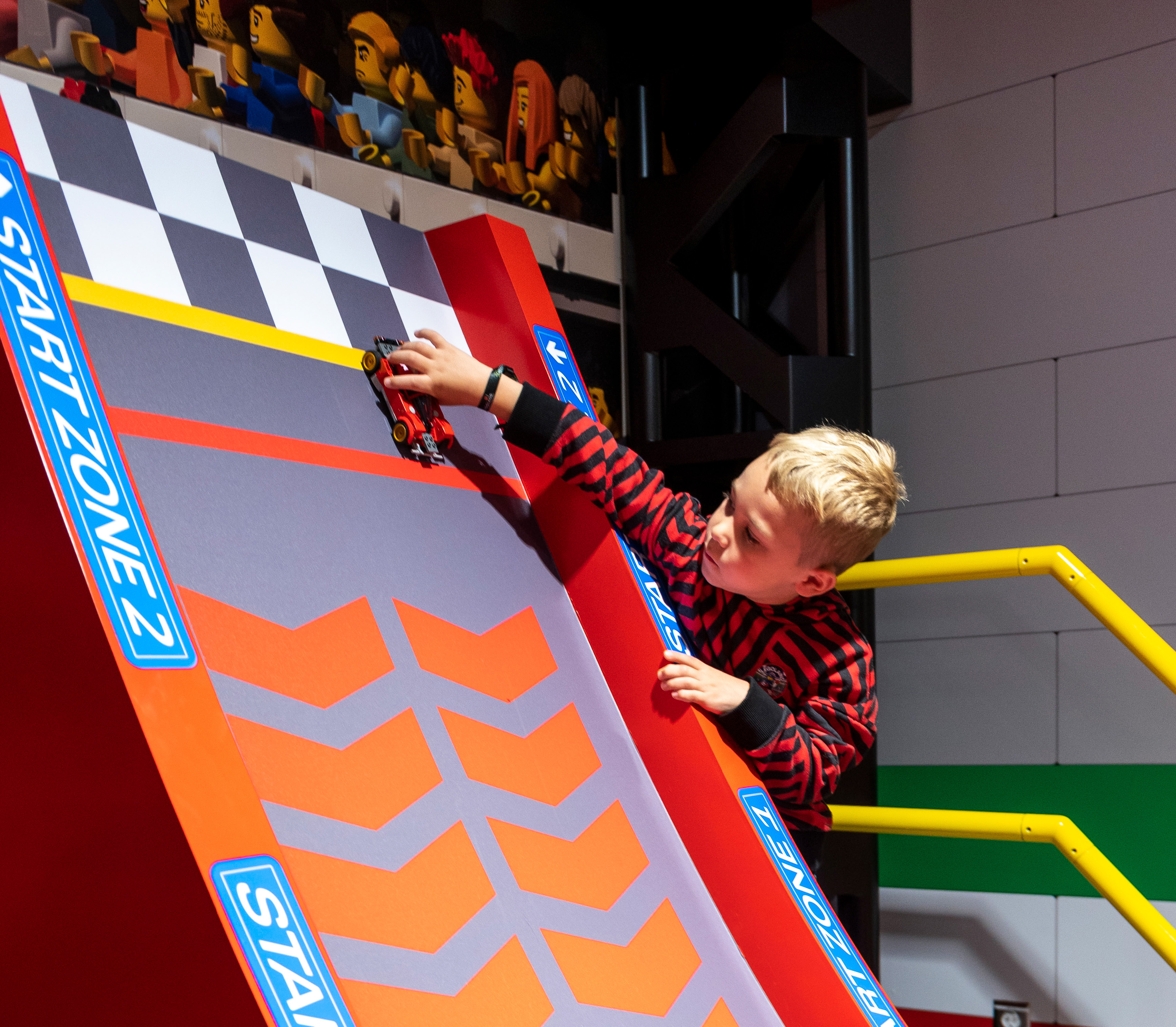 Child building LEGO car